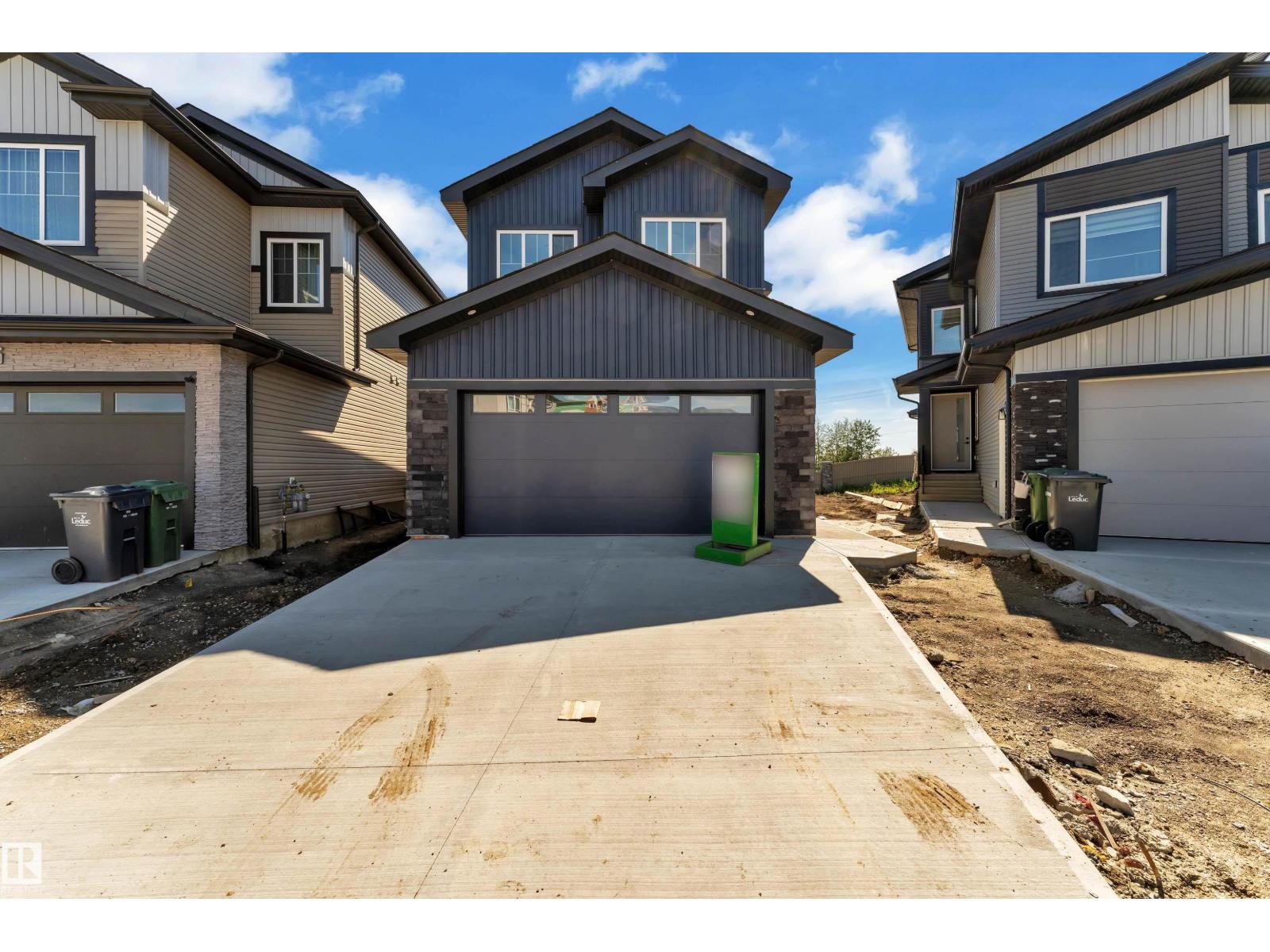 Representative double attached garage and driveway, at this finish level
