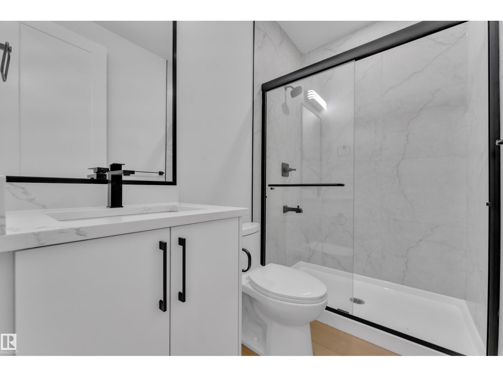 Representative main bathroom with glass shower, at this finish level