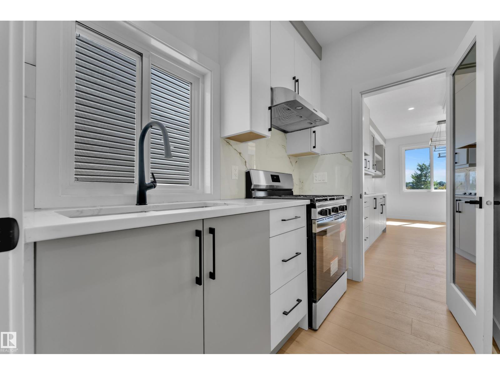 Representative kitchen sink beneath window, at this finish level
