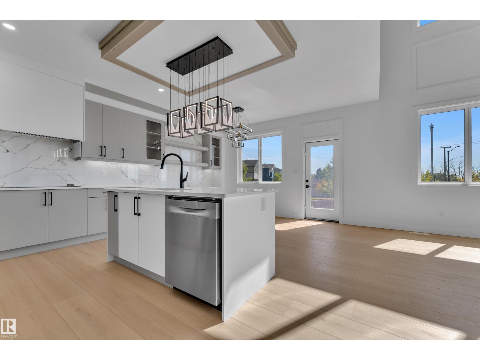 Representative kitchen island with pendant lighting and tray ceiling, at this finish level