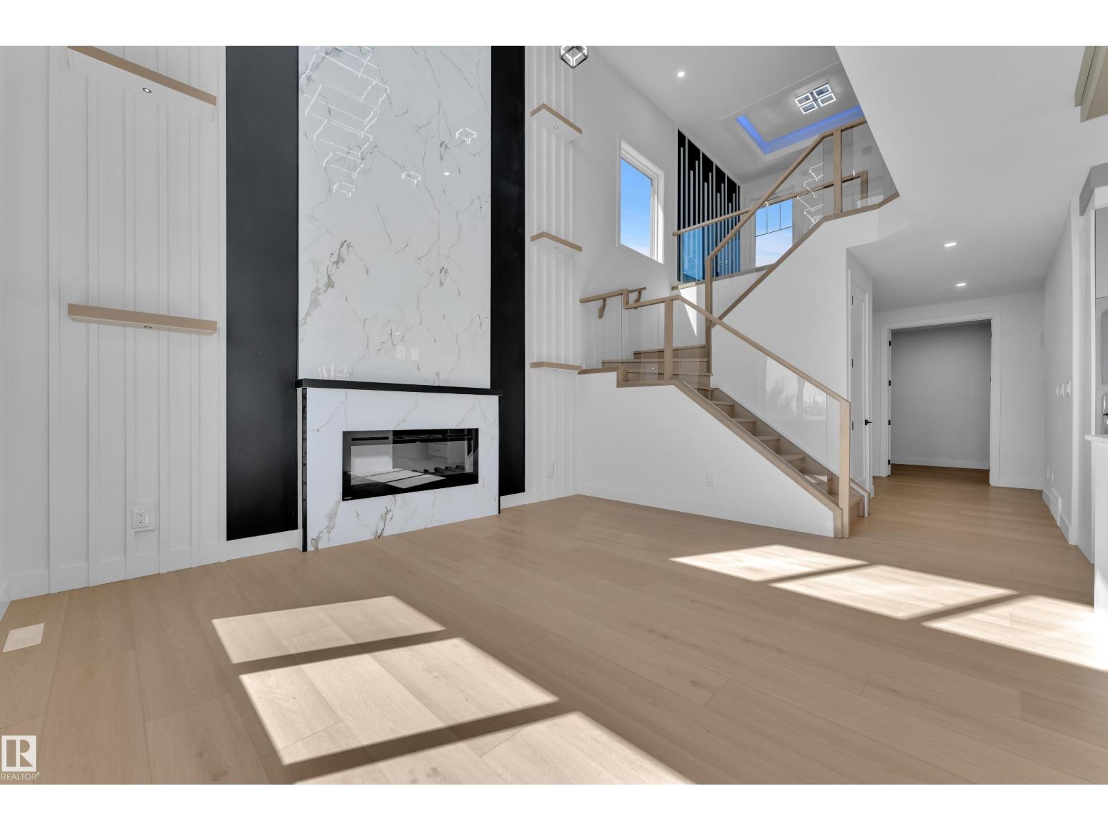 Representative great room fireplace and staircase, at this finish level