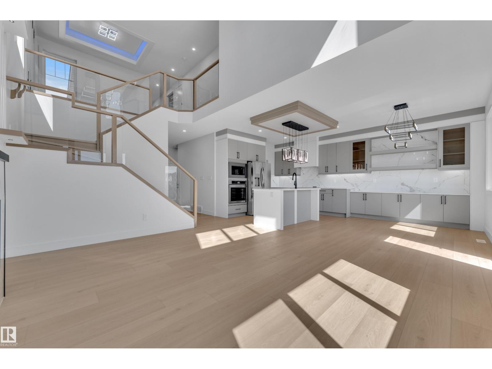 Representative kitchen open to staircase above, at this finish level