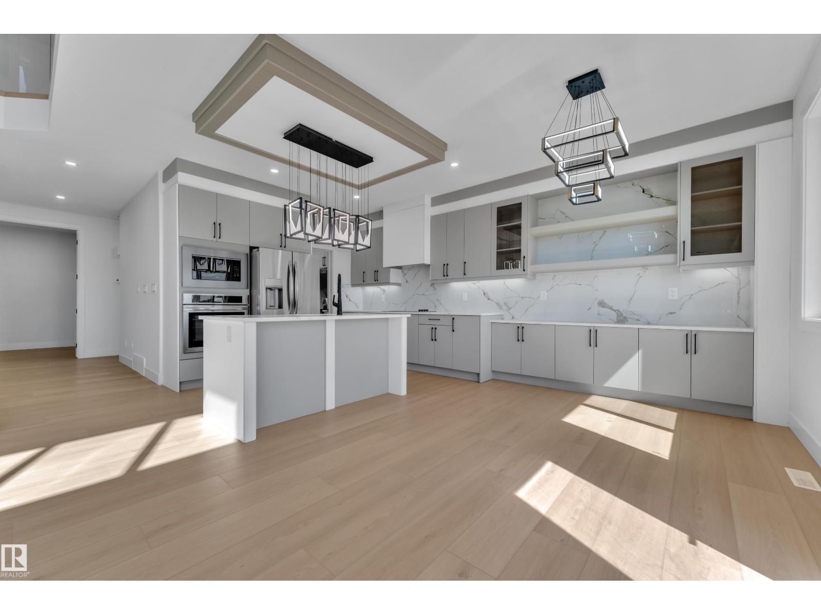 Representative kitchen with linear pendant lighting, at this finish level